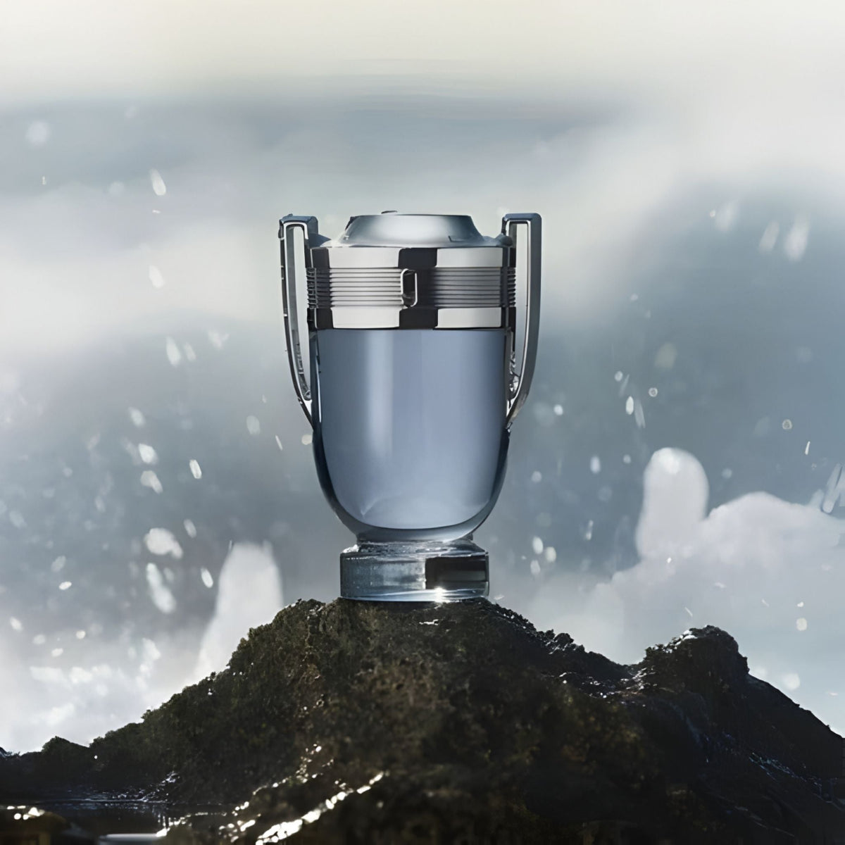 Refect Beauty Paco Rabanne Invictus trophy-shaped perfume bottle on a rocky shore with splashing ocean waves