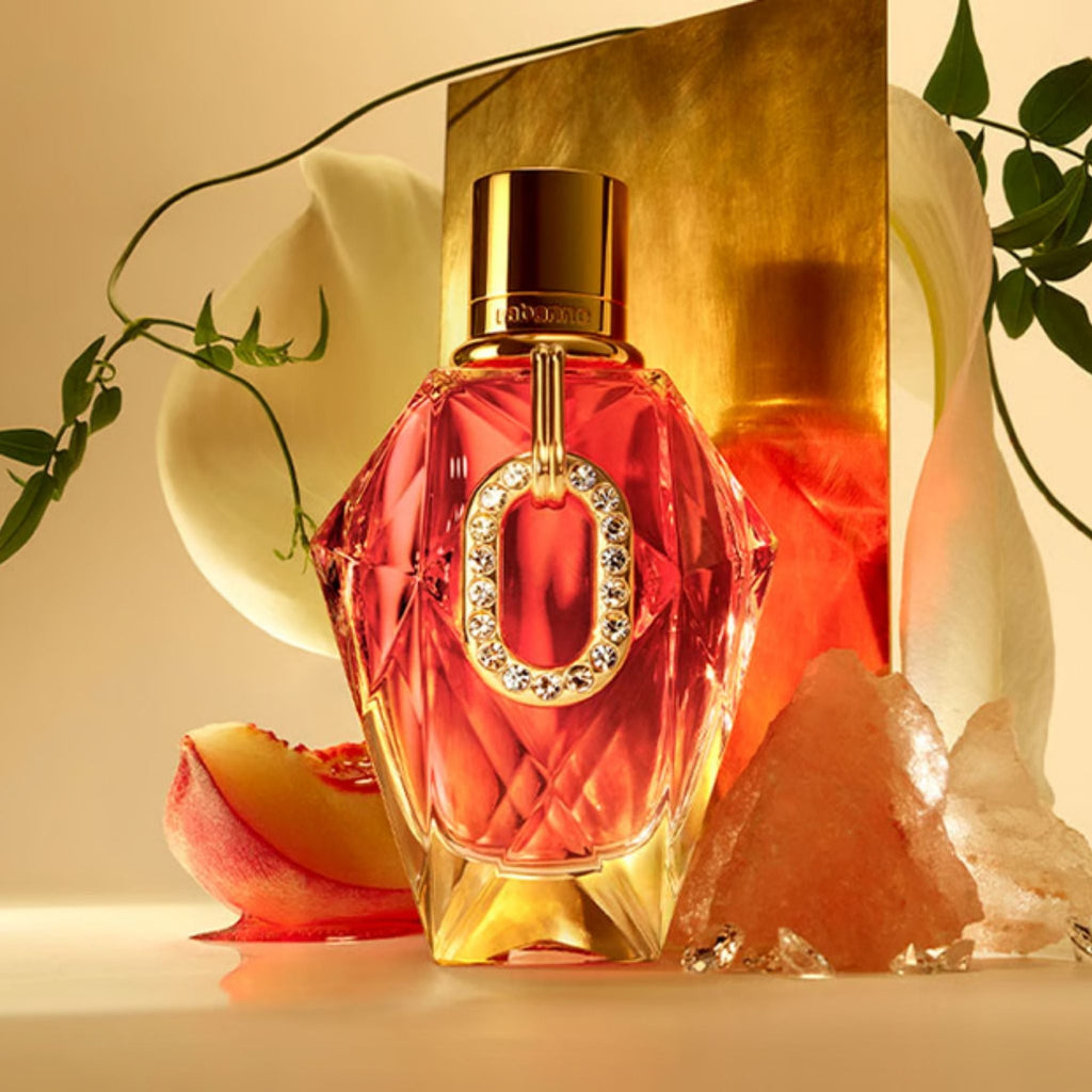Refect Beauty Paco Rabanne Million Gold Pure Diamonds perfume bottle with crystal accents and floral background