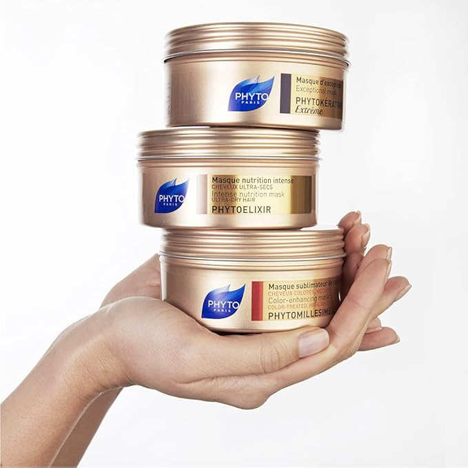 Refect Beauty presents a stack of three Phyto hair masks in gold jars held in a person's hand for hair repair.
