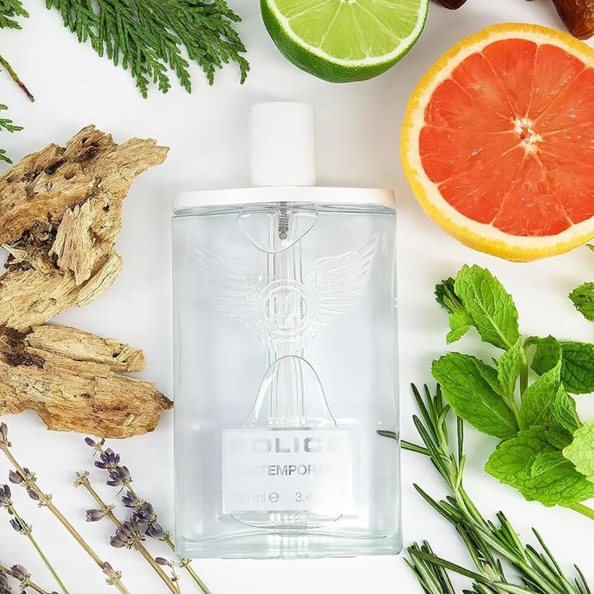 Refect Beauty Police Contemporary Eau de Toilette bottle surrounded by fresh grapefruit, mint, and woody elements.
