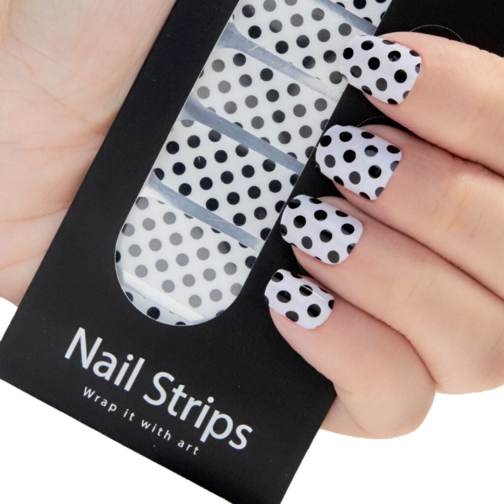 Refect Beauty Yolo nail strips featuring a black and white polka dot pattern applied to fingernails Main image