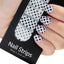 Refect Beauty Yolo nail strips featuring a black and white polka dot pattern applied to fingernails