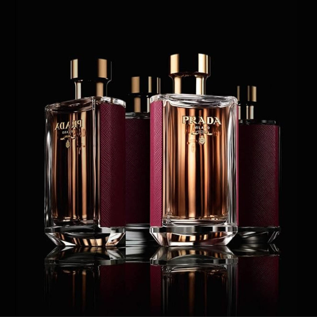 Refect Beauty Prada La Femme Intense Eau de Parfum bottles with gold caps and burgundy textured sides on black glass