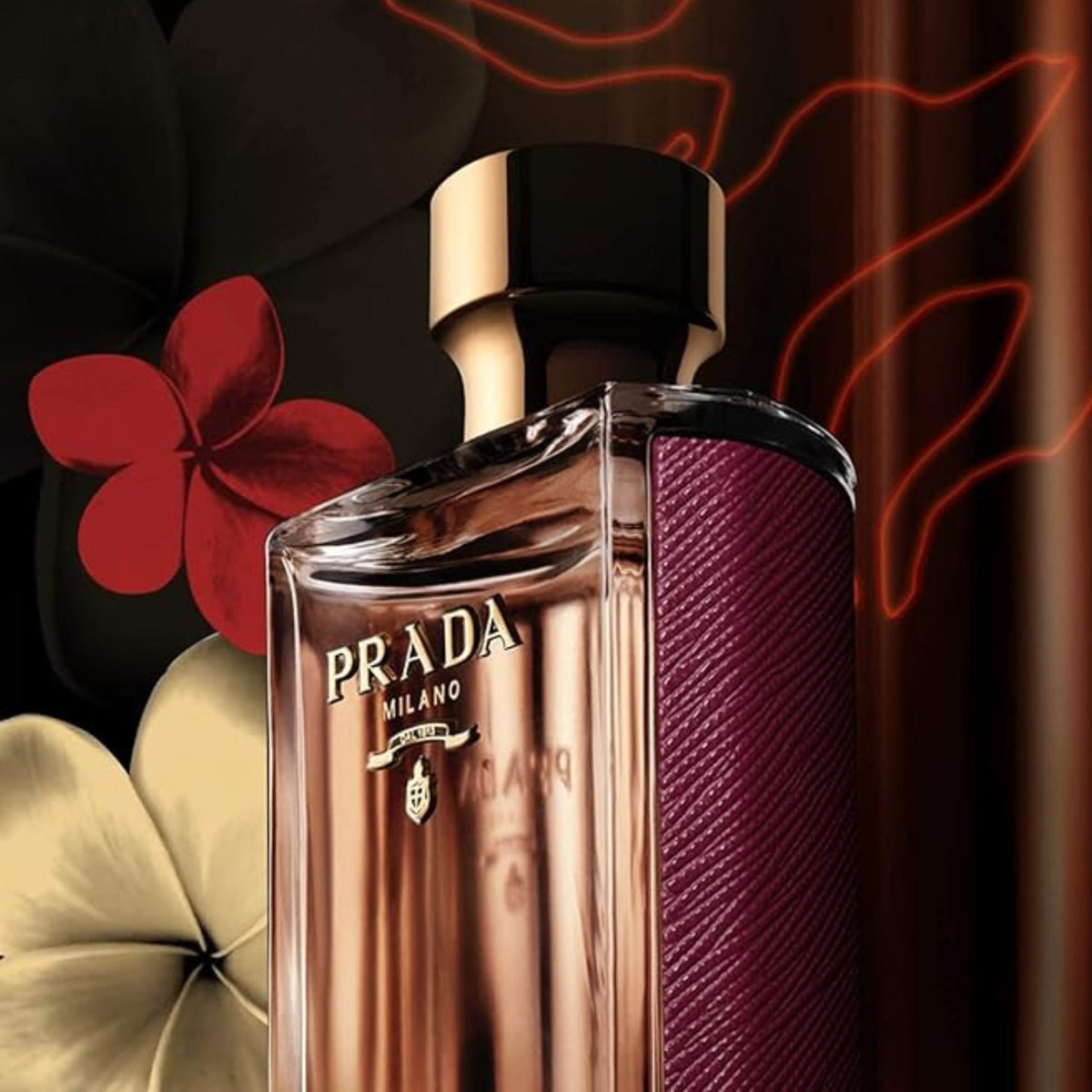 Refect Beauty Prada La Femme Intense Eau de Parfum bottle with deep red textured side and gold cap against floral art