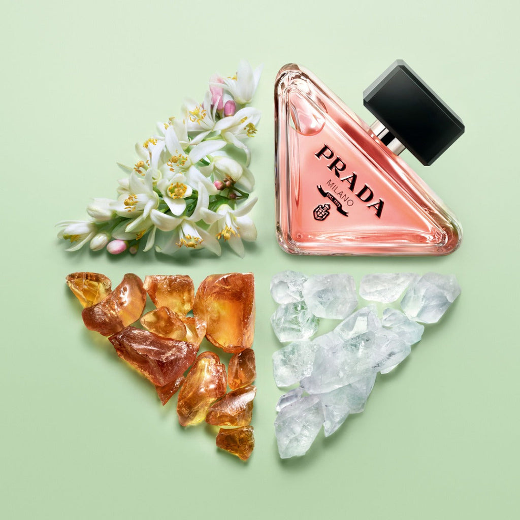 Refect Beauty Prada Paradoxe Eau de Parfum bottle with orange blossoms, amber, and crystals on a green background