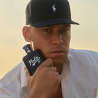 Refect Beauty model wearing a black cap holding a navy blue Ralph Lauren Polo 67 Eau de Toilette refillable bottle