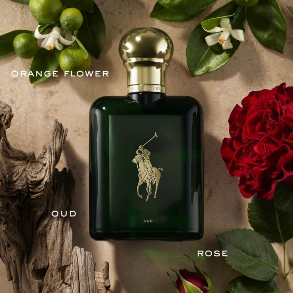Refect Beauty Ralph Lauren Polo Oud Eau de Parfum bottle surrounded by orange flowers, red roses, and driftwood.
