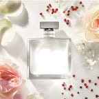 Refect Beauty Ralph Lauren Romance Eau de Parfum bottle surrounded by soft pink rose petals and red berries