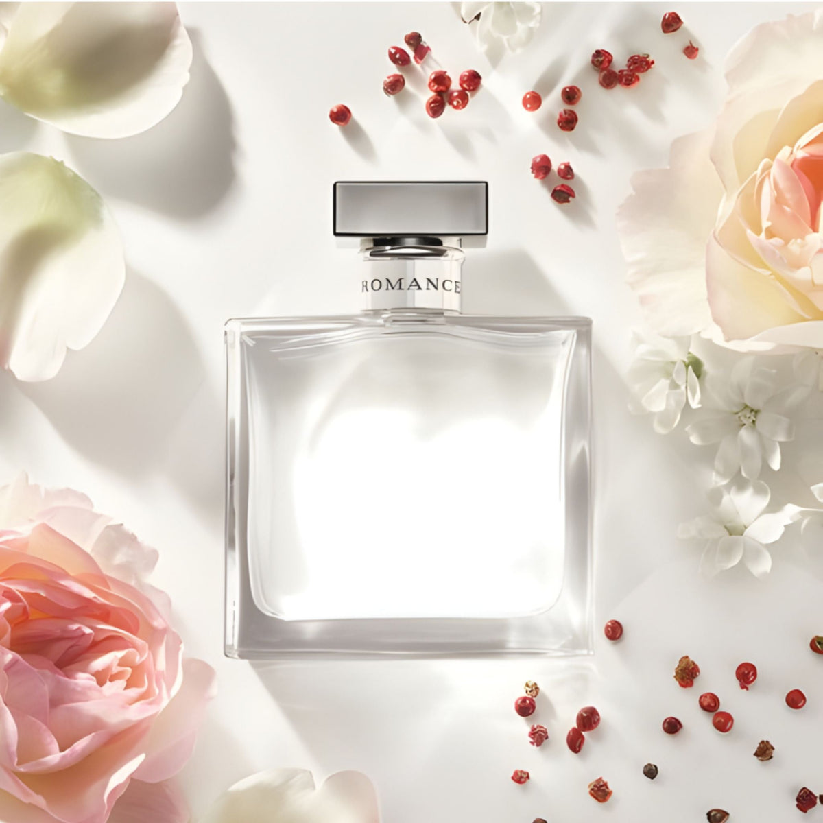 Refect Beauty Ralph Lauren Romance Eau de Parfum bottle surrounded by soft pink rose petals and red berries