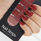 Refect Beauty Yolo nail strips featuring a vibrant red glitter finish applied to fingernails for a salon-style look.
