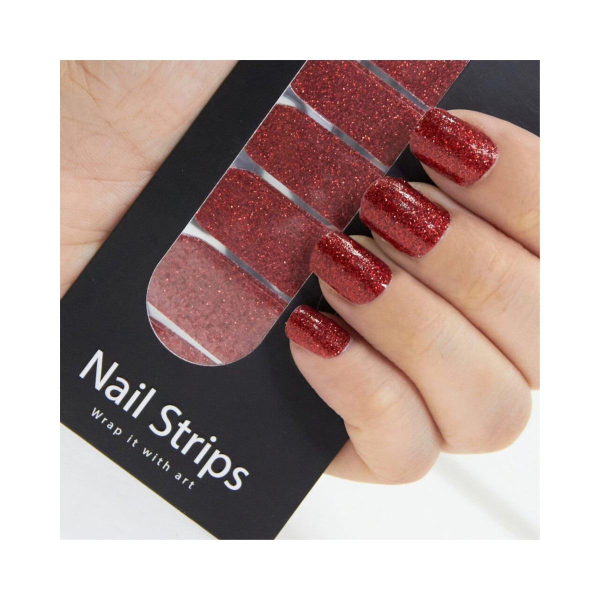 Refect Beauty Yolo nail strips in sparkling red glitter applied to fingers, held against the product packaging.