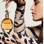 Refect Beauty Roberto Cavalli Eau de Parfum bottle held by a woman wearing a tiger print top with gold nails