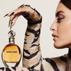 Refect Beauty Roberto Cavalli Eau de Parfum bottle held by a woman wearing a tiger print top