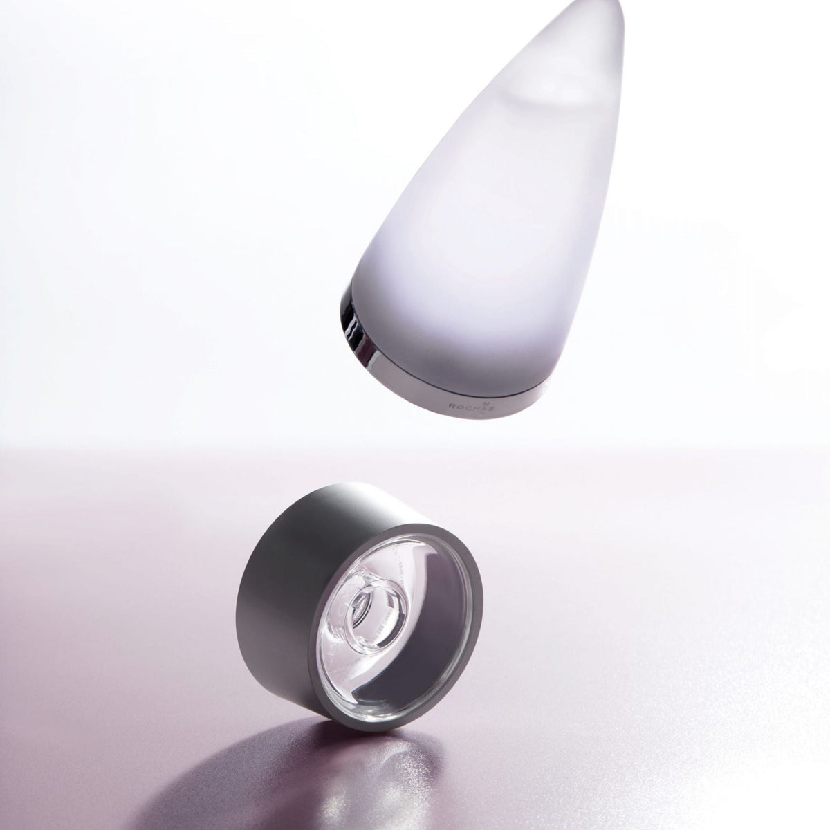 Refect Beauty Rochas Man Eau de Toilette bottle and cap floating against a soft light background