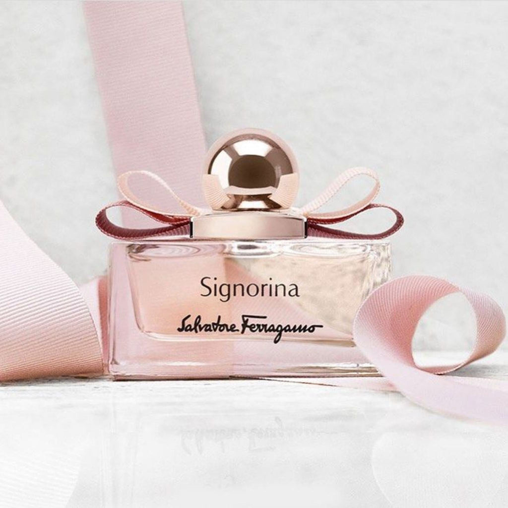 Refect Beauty Salvatore Ferragamo Signorina Eau de Parfum bottle with a pink ribbon bow on a white surface