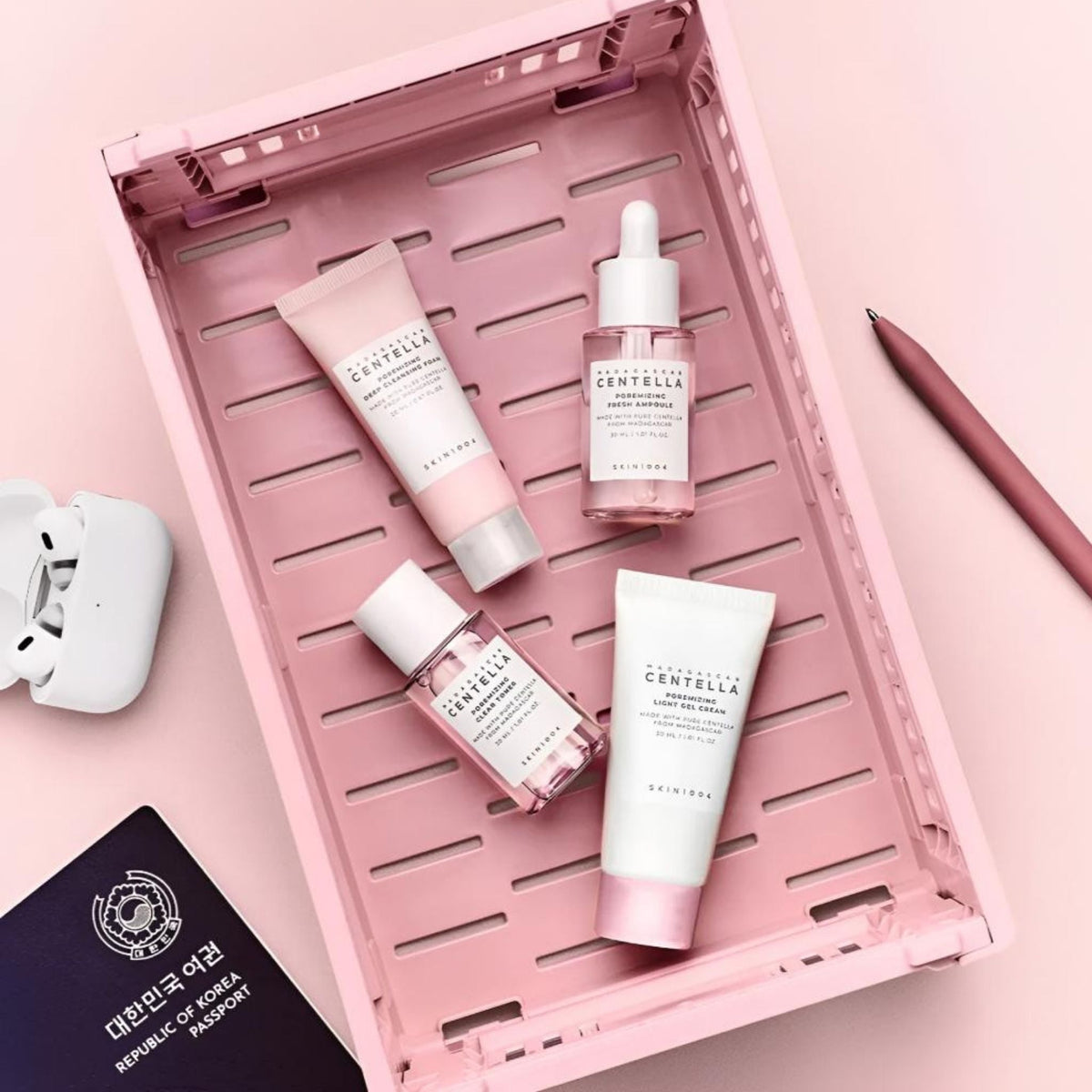 Refect Beauty SKIN1004 Centella Poremizing travel kit featuring cleanser, toner, ampoule, and gel cream in a pink crate.