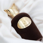 Refect Beauty Sospiro Il Padrino Eau de Parfum in a dark brown velvet bottle with a gold cap on white fabric.