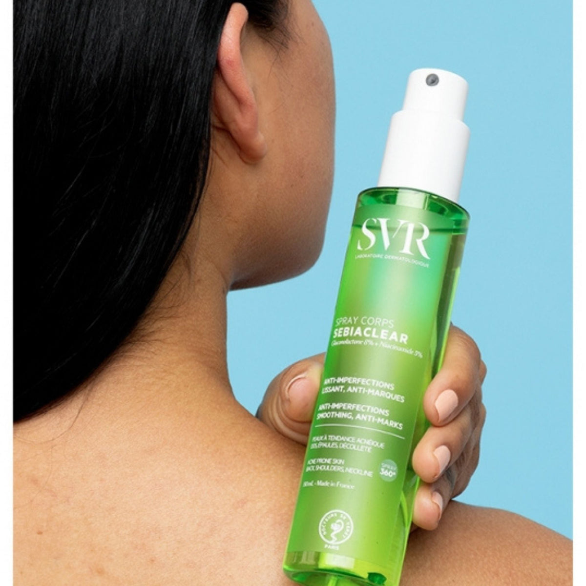 Refect Beauty SVR Sebiaclear body spray being applied to shoulder to treat blemishes and acne-prone skin