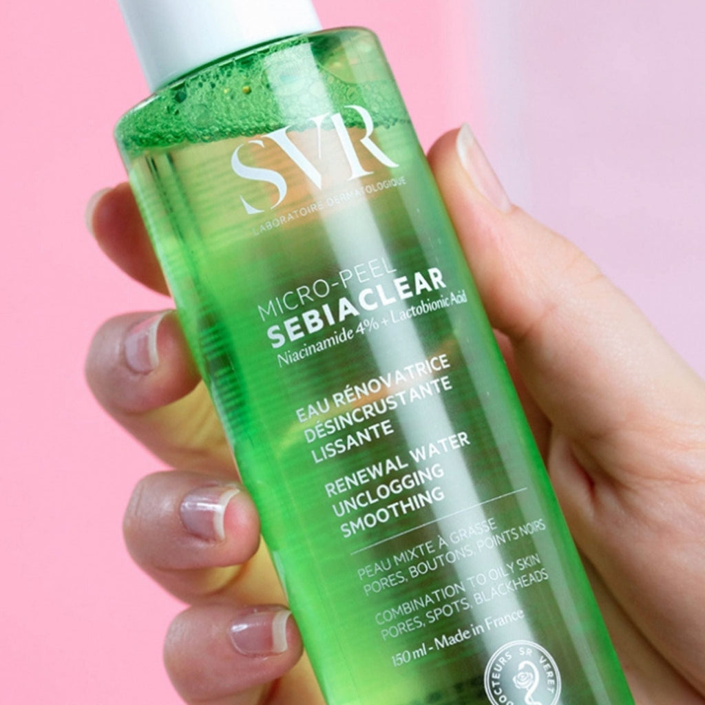 Refect Beauty SVR Sebiaclear Micro-Peel exfoliating renewal water in a green bottle held in a hand
