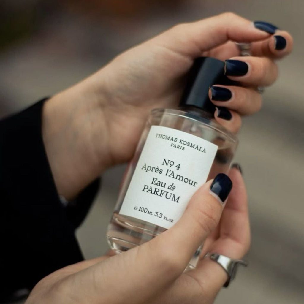 Refect Beauty Thomas Kosmala No. 4 Après l’Amour perfume bottle held in hands with dark nail polish