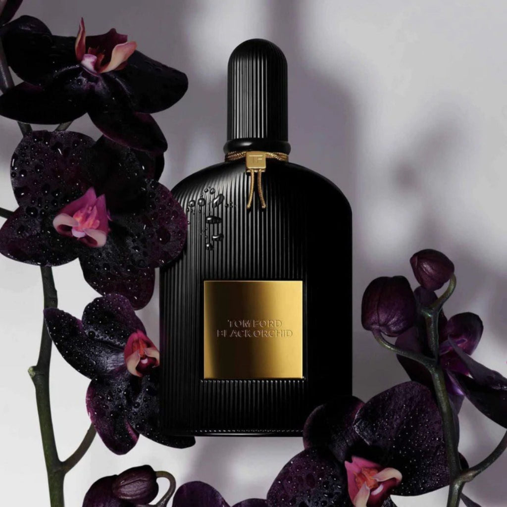 Refect Beauty Tom Ford Black Orchid Eau de Parfum bottle surrounded by dark purple orchids with water droplets