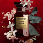 Refect Beauty Tom Ford Jasmin Rouge Eau de Parfum bottle surrounded by white jasmine flowers on a deep red background.