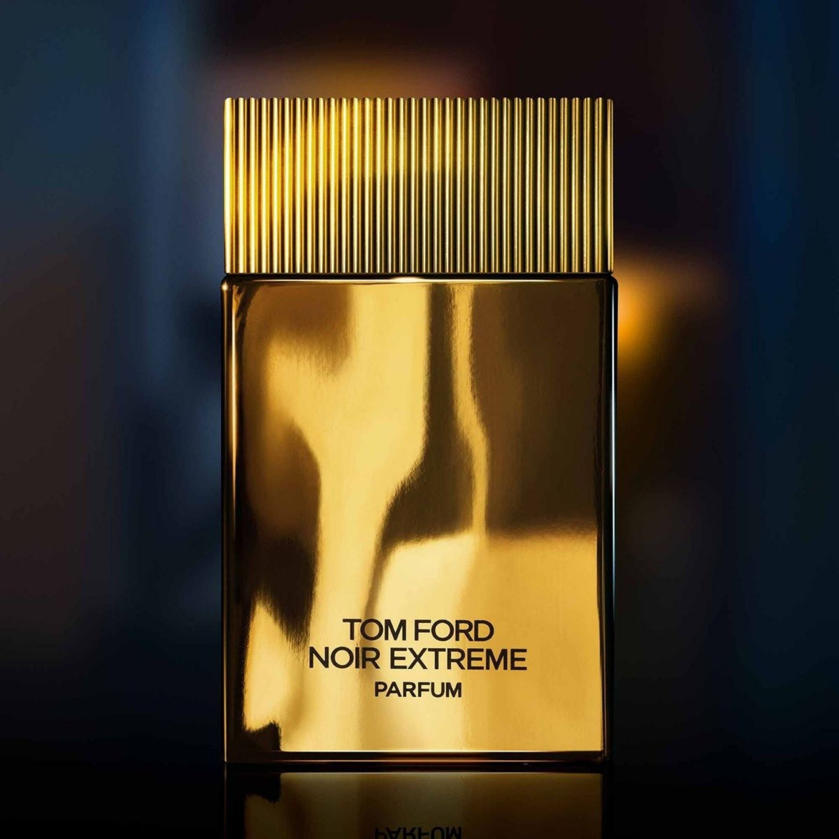 Refect Beauty Tom Ford Noir Extreme Parfum in a sleek, reflective gold bottle with a ribbed cap for men.