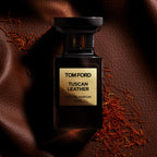 Refect Beauty Tom Ford Tuscan Leather Eau de Parfum bottle on a textured brown leather background with saffron strands.