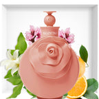 Refect Beauty Valentino Blush Eau de Parfum in a round pink bottle with a rose design, surrounded by floral accents.