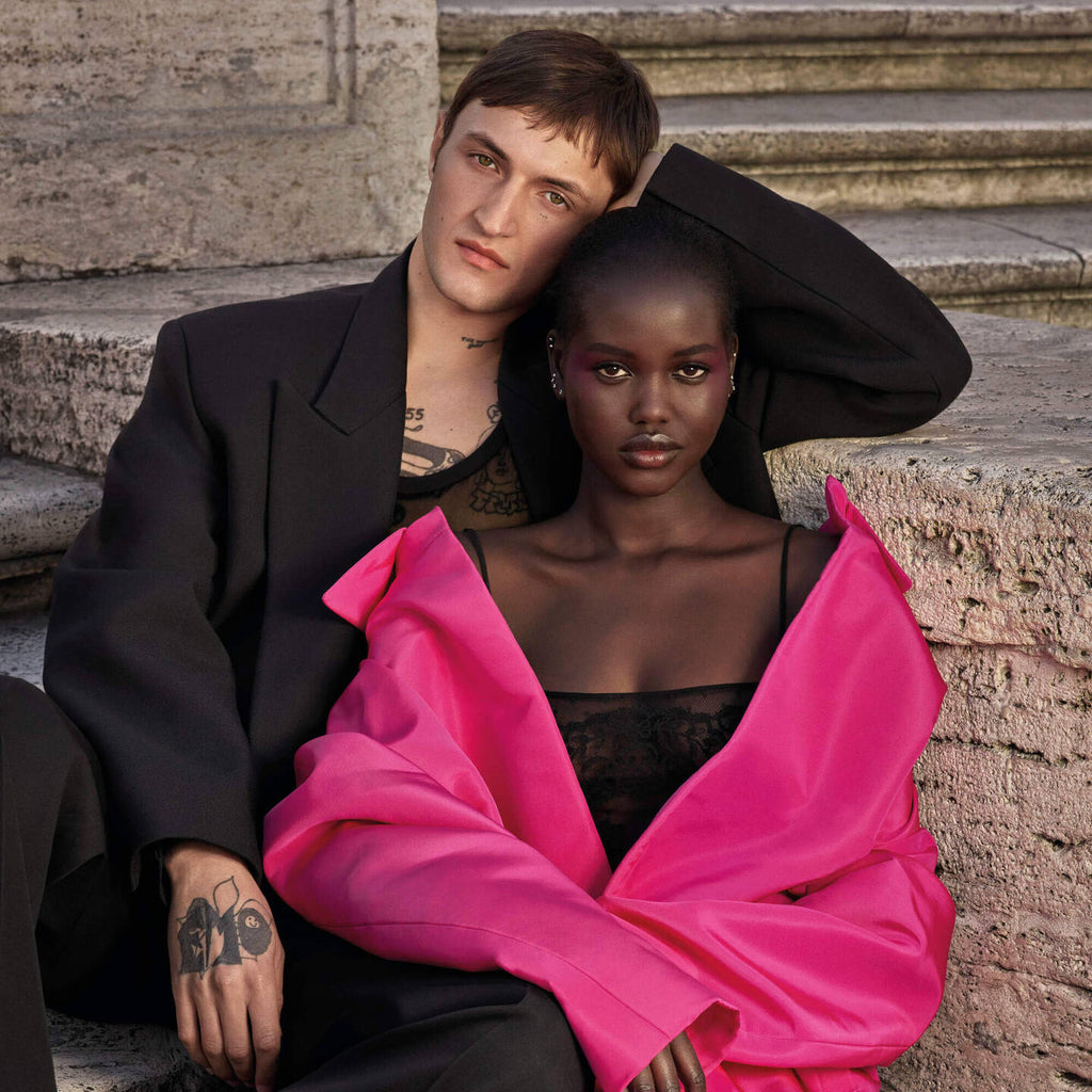 Refect Beauty campaign featuring a man and woman posing on stone steps, promoting Valentino Born in Roma Uomo Extradose