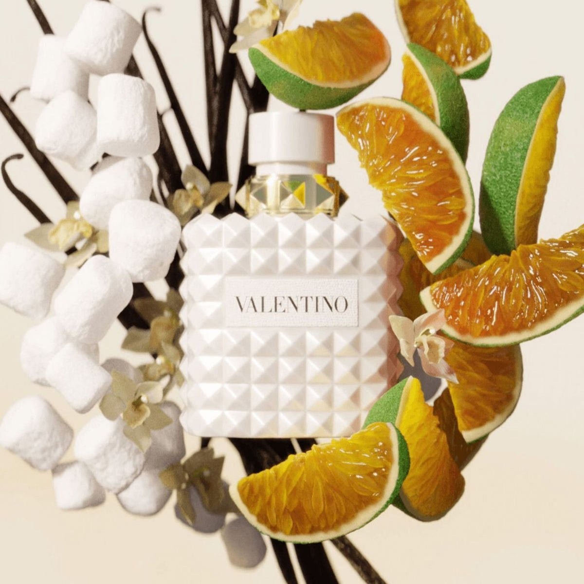 Refect Beauty Valentino Born In Roma Donna Ivory perfume bottle surrounded by marshmallows, citrus slices, and vanilla.