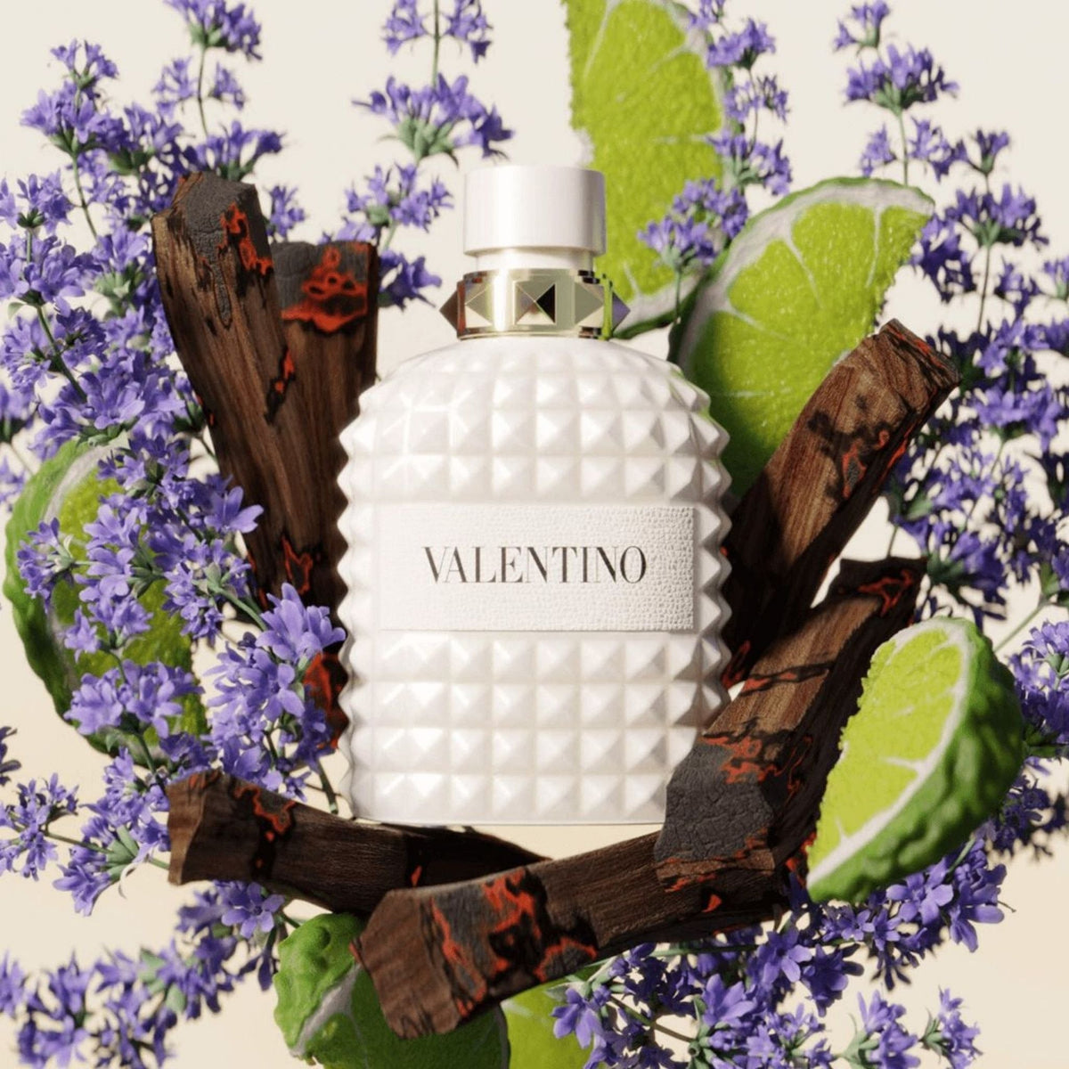 Refect Beauty Valentino Born In Roma Uomo Ivory fragrance bottle surrounded by lavender, lime slices, and wood pieces.