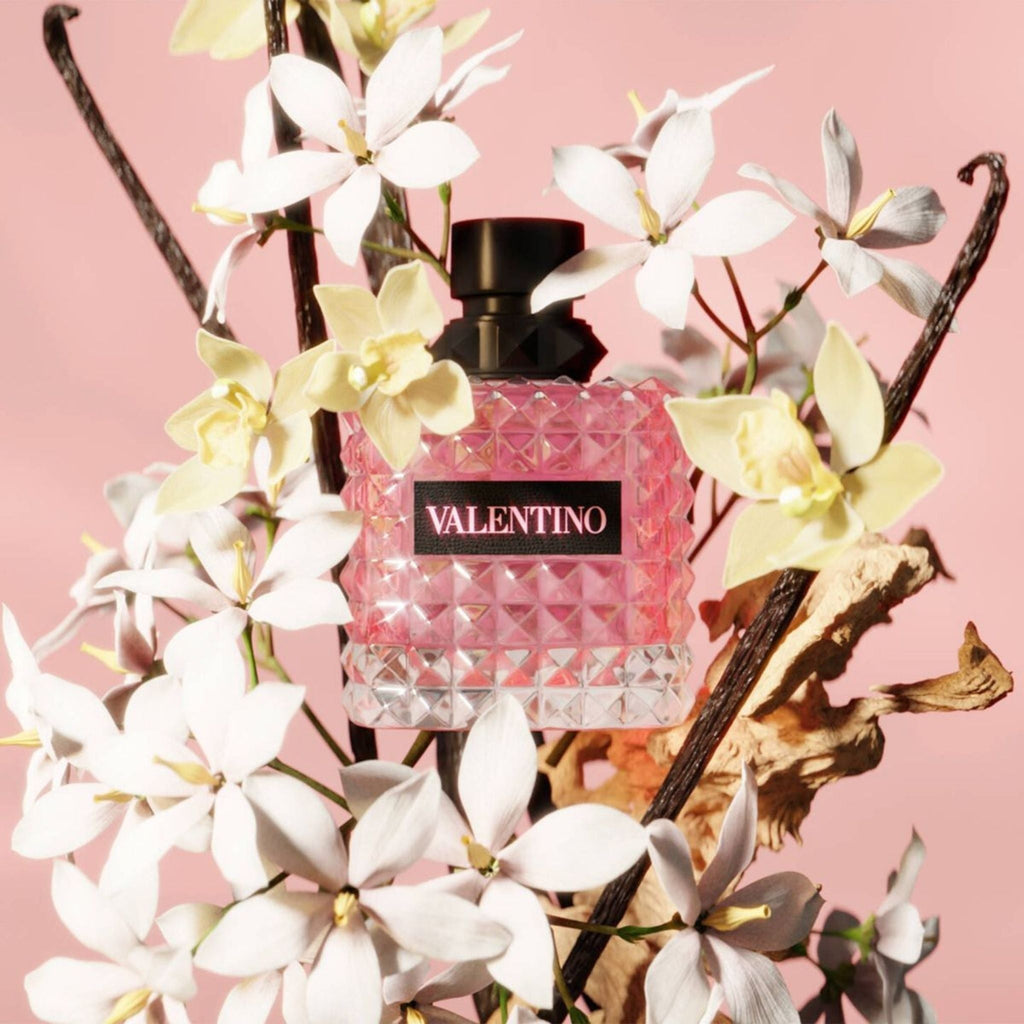 Refect Beauty Valentino Donna Born In Roma perfume bottle surrounded by white jasmine flowers and vanilla beans