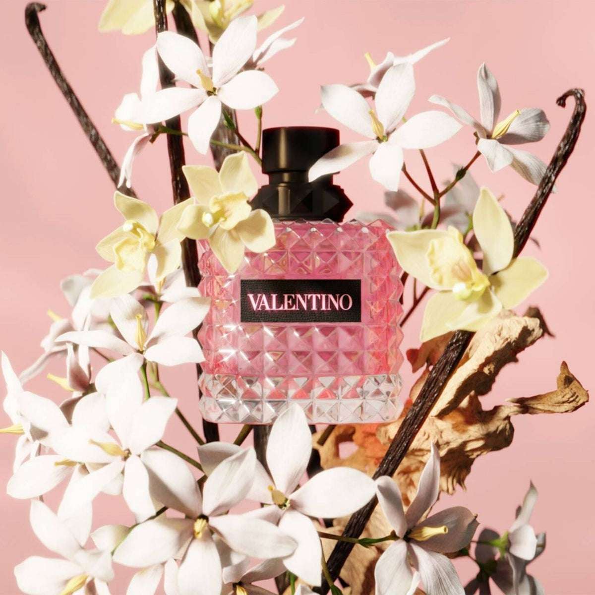 Refect Beauty Valentino Donna Born In Roma perfume bottle surrounded by white jasmine flowers and vanilla beans
