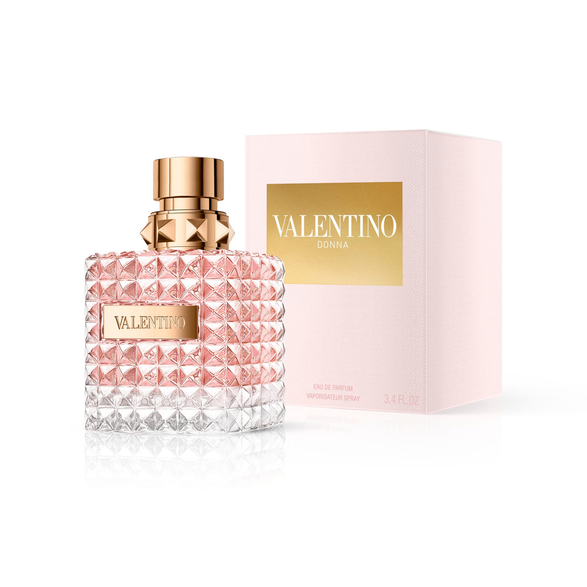 Refect Beauty Valentino Donna Eau de Parfum in a glass bottle with a studded design next to its pale pink box.