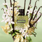 Refect Beauty Valentino Donna Born In Roma Green Stravaganza perfume bottle surrounded by jasmine and vanilla beans