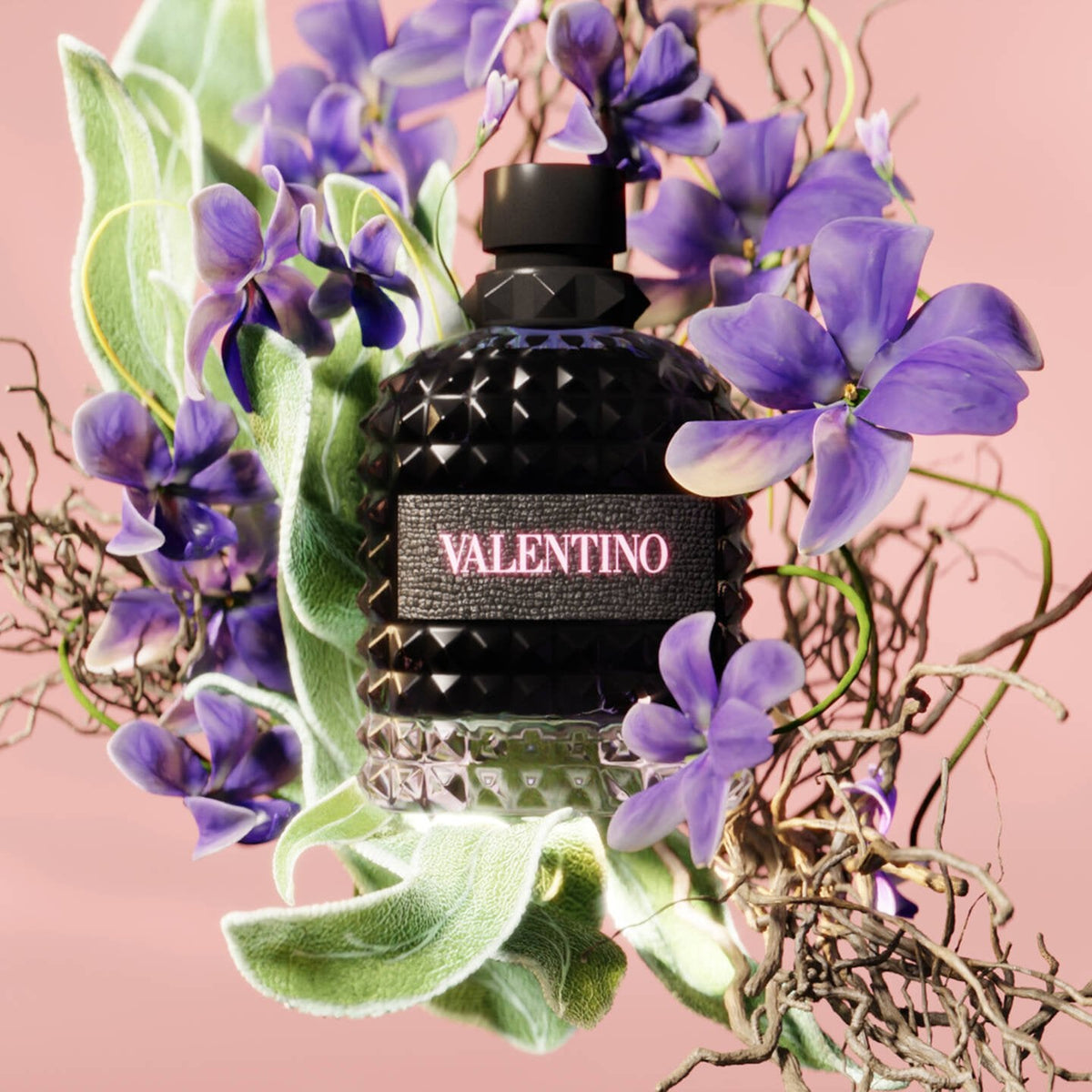 Refect Beauty Valentino Uomo Born In Roma fragrance bottle surrounded by violet flowers and sage leaves