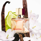 Refect Beauty Valentino Voce Viva Intense perfume bottle surrounded by vanilla beans, bergamot slices, and white flowers