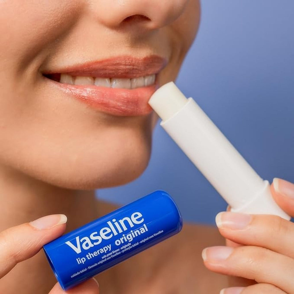 Refect Beauty model applying Vaseline Lip Therapy Original stick to moisturize and protect dry lips