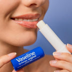 Refect Beauty model applying Vaseline Lip Therapy Original stick to moisturize and protect dry lips