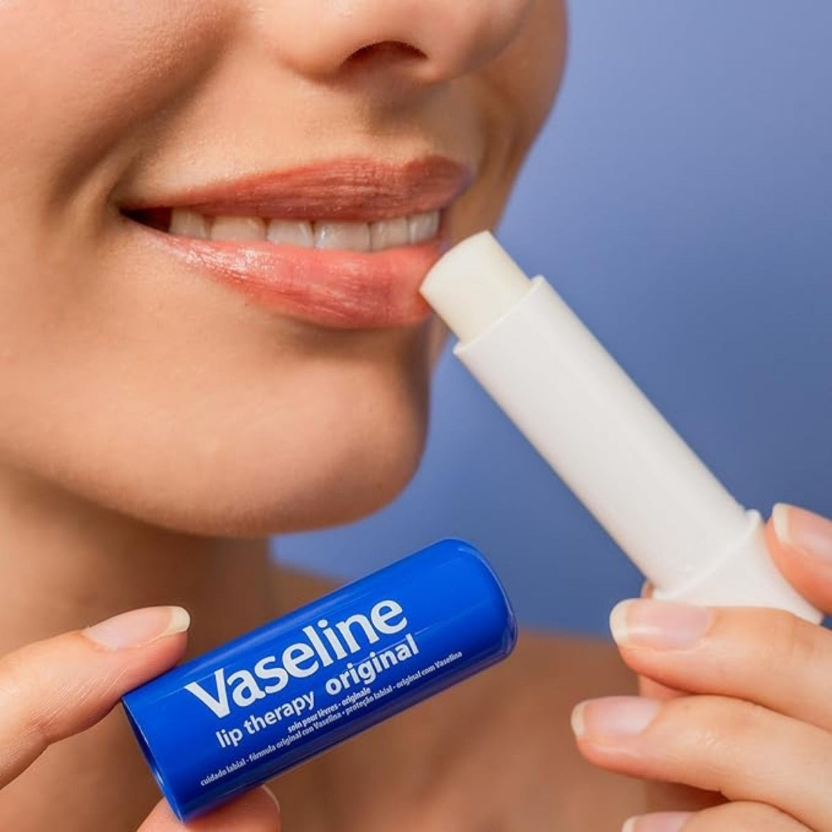 Refect Beauty model applying Vaseline Lip Therapy Original stick to moisturize and protect dry lips