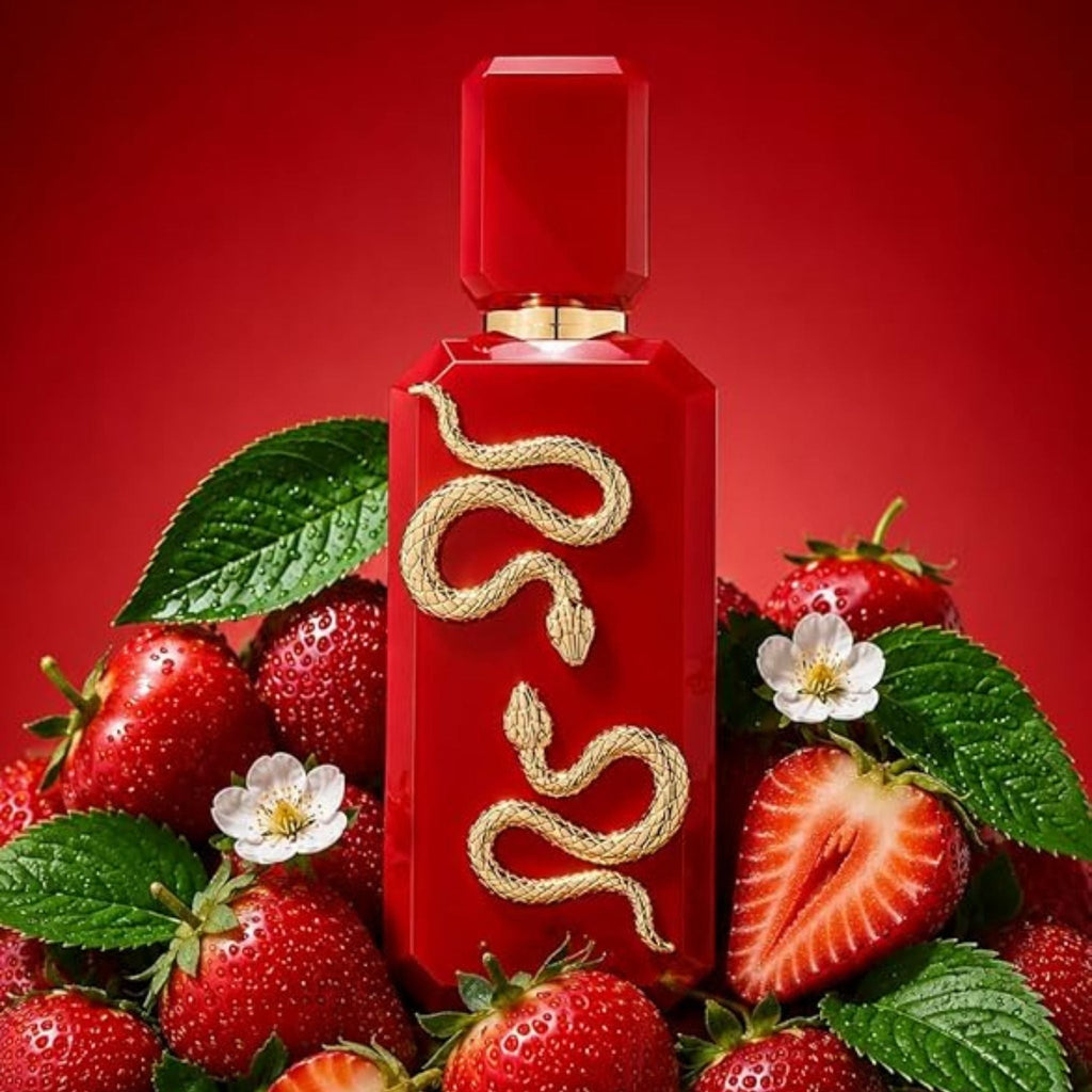 Refect Beauty French Avenue Veneno Scarlet perfume bottle with a gold snake emblem surrounded by fresh strawberries.