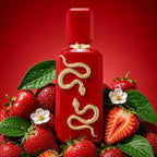 Refect Beauty French Avenue Veneno Scarlet perfume bottle with a gold snake emblem surrounded by fresh strawberries.