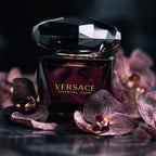Refect Beauty Versace Crystal Noir Eau de Parfum bottle with a large faceted black cap surrounded by dark orchids