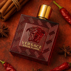 Refect Beauty Versace Eros Flame Eau de Parfum in a red glass bottle with gold cap, surrounded by spices and chili.