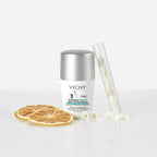 Refect Beauty Vichy Invisible Resist 72H roll-on deodorant with dried citrus slices and white flowers on white surface.