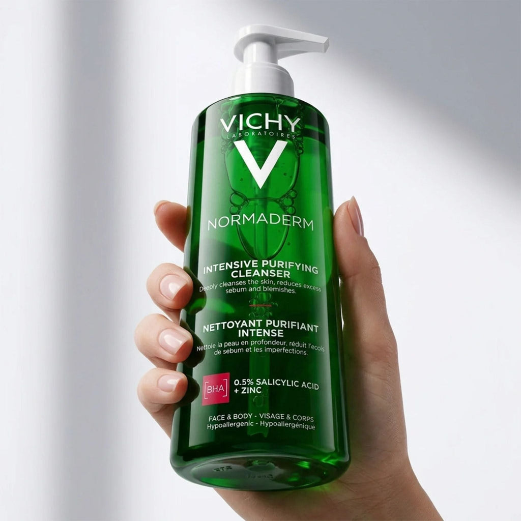 Refect Beauty Vichy Normaderm anti-acne purifying gel cleanser in a green pump bottle held in a hand.
