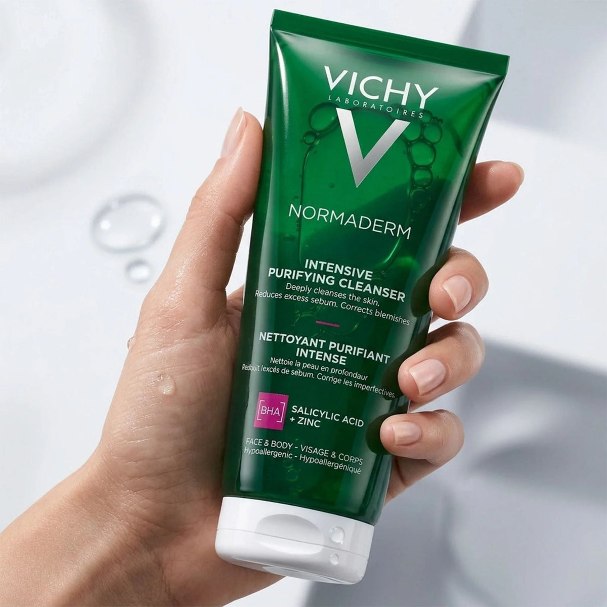 Refect Beauty Vichy Normaderm anti-acne purifying gel cleanser in a green squeeze tube held in a hand