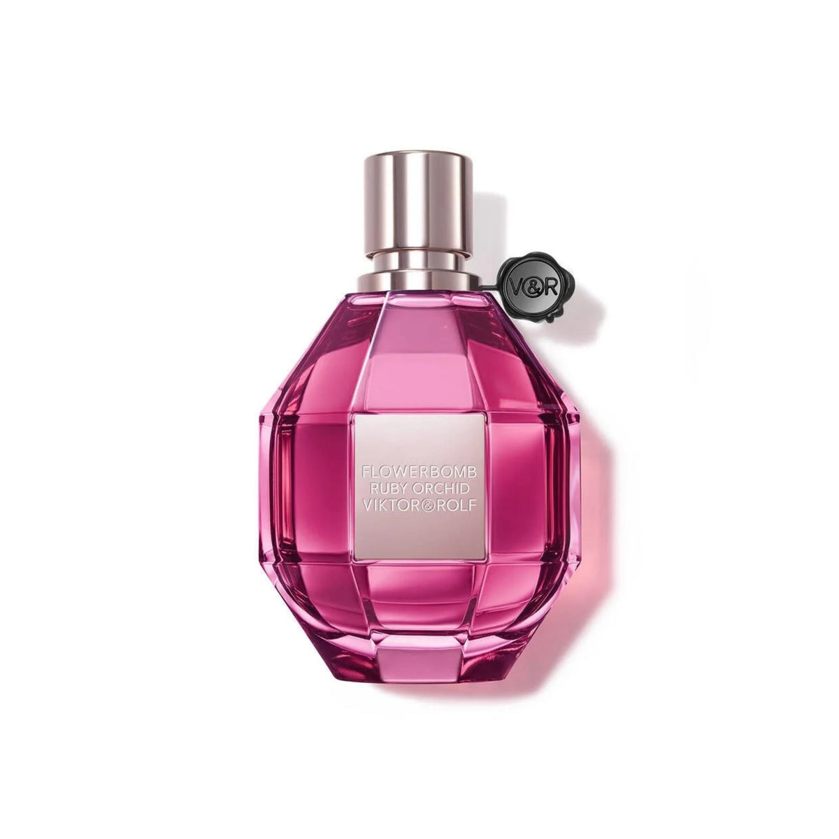 Refect Beauty Viktor & Rolf Flowerbomb Ruby Orchid perfume in a faceted pink glass bottle with a metallic cap.
