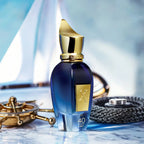 Refect Beauty Xerjoff 40 Knots Eau de Parfum in a blue glass bottle with a gold cap, set against a nautical background.